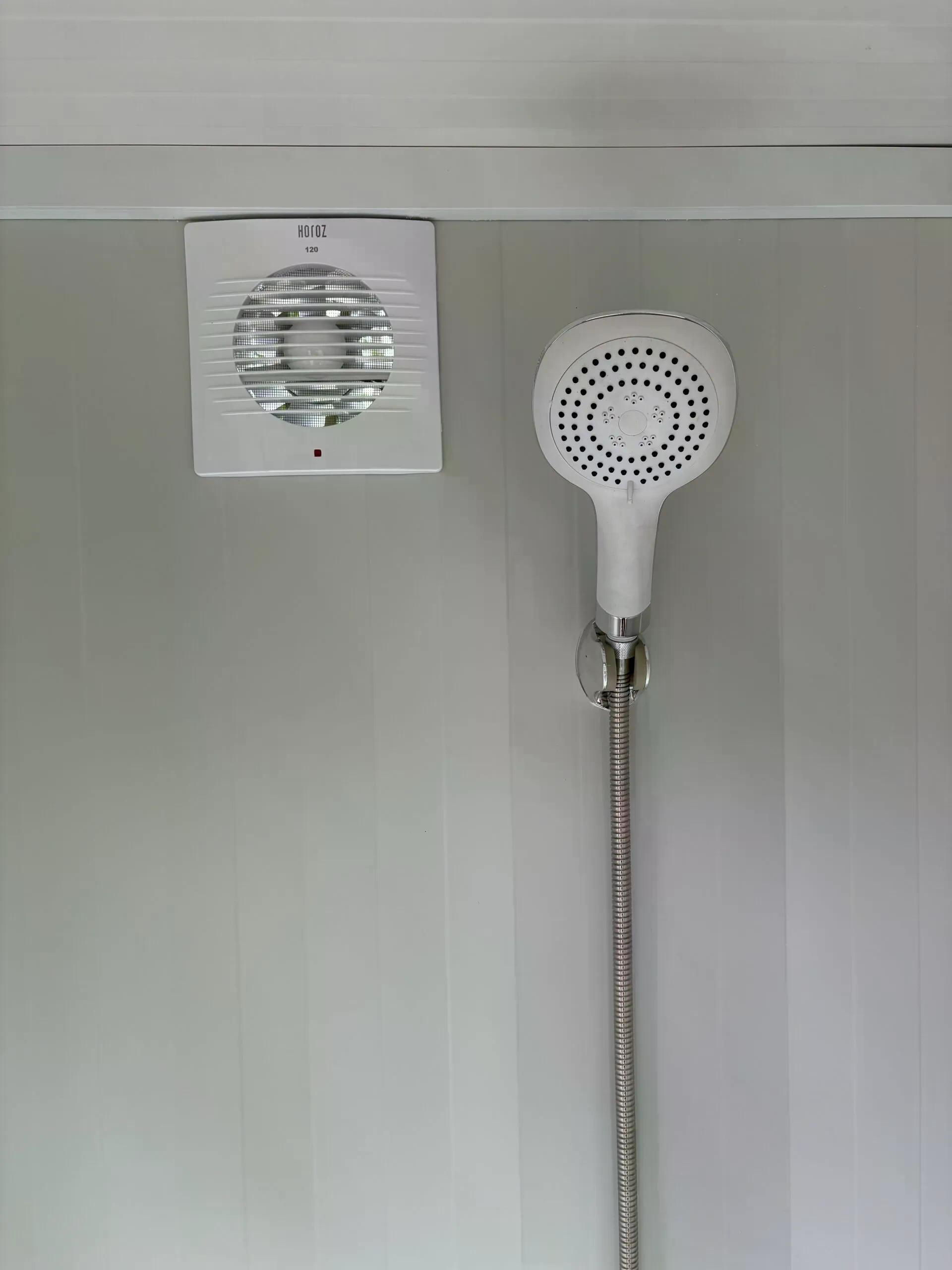 Shower head and ventilation inside a dual portable shower unit.