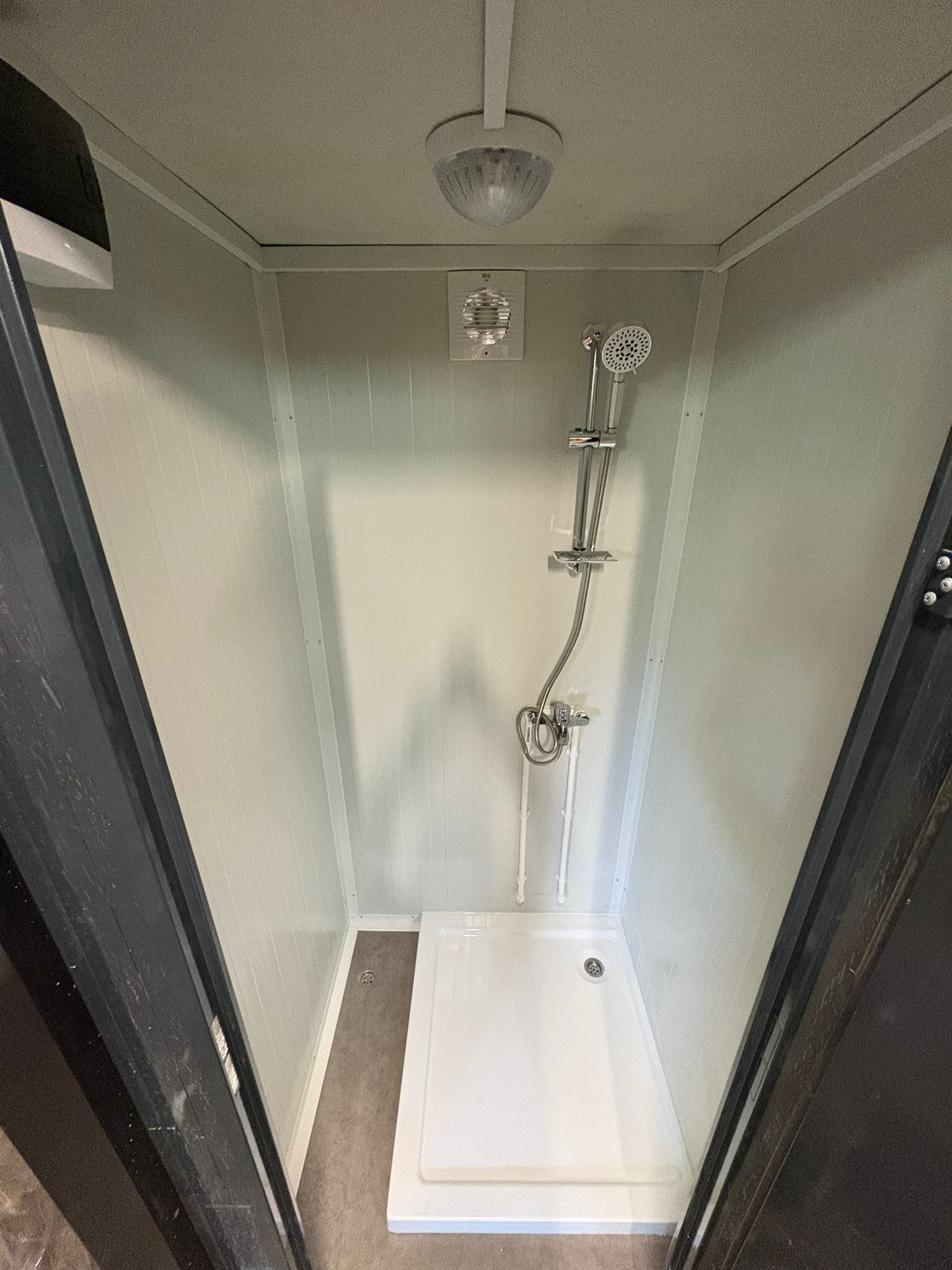 Interior close-up of a luxury portable shower unit for camping.