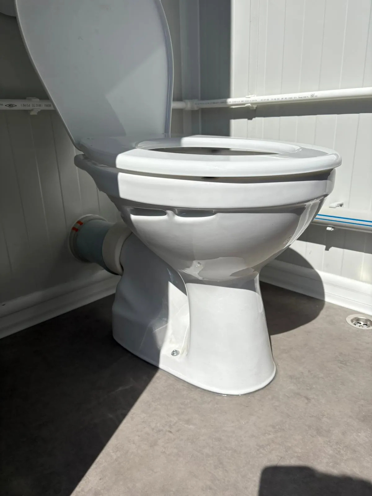 Toilet inside a portable bathroom unit.