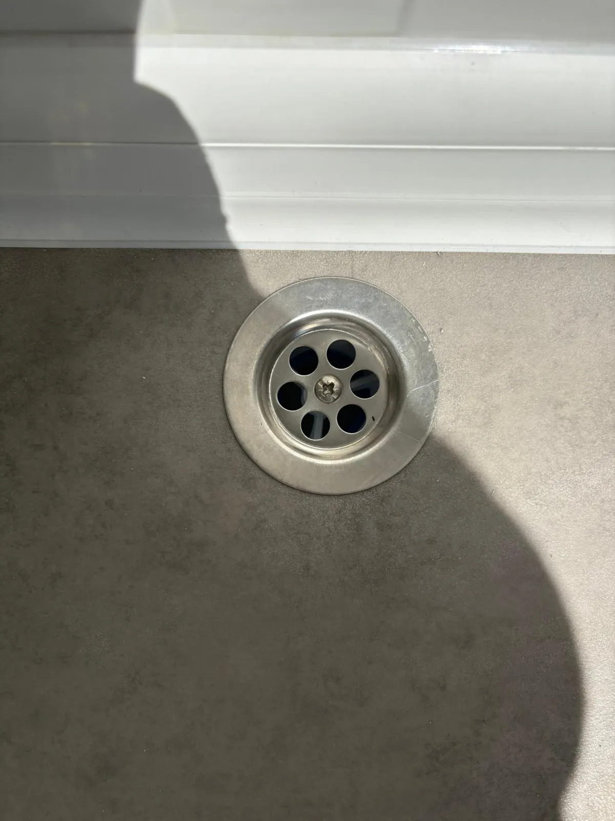 Floor drainage inside a portable handicap toilet unit.