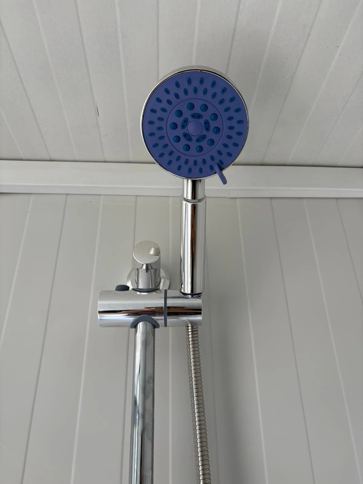 Shower head inside a portable handicap toilet unit.