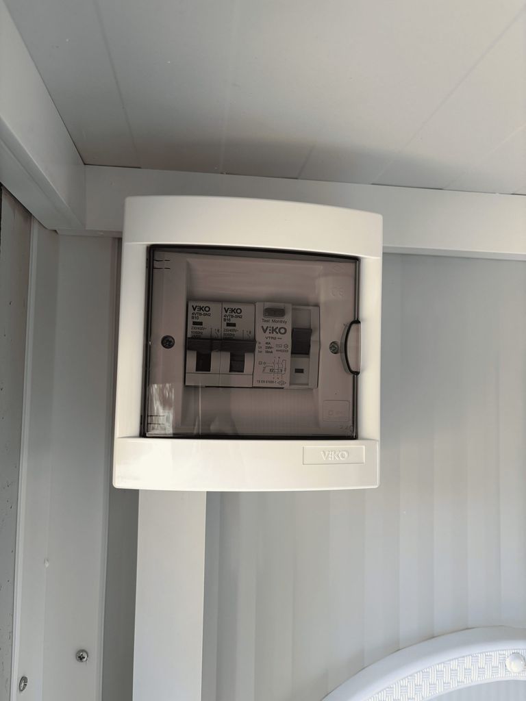 Fuse box inside a portable toilet unit for camping.