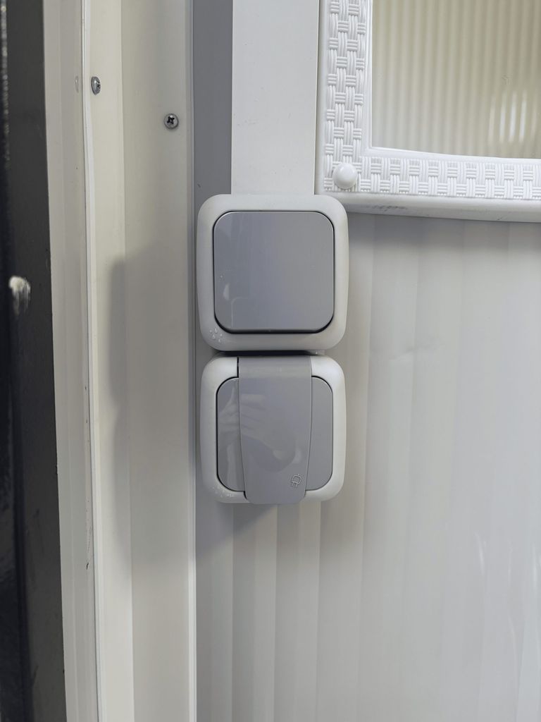 Light switch inside a portable toilet unit for camping.